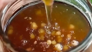 Botella atomizadora con solución casera de vinagre y pimienta junto a sus ingredientes para repeler mascotas