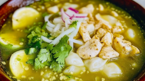 Authentic pozole verde pollo recipe served in ceramic bowl with fresh toppings and Mexican garnishes